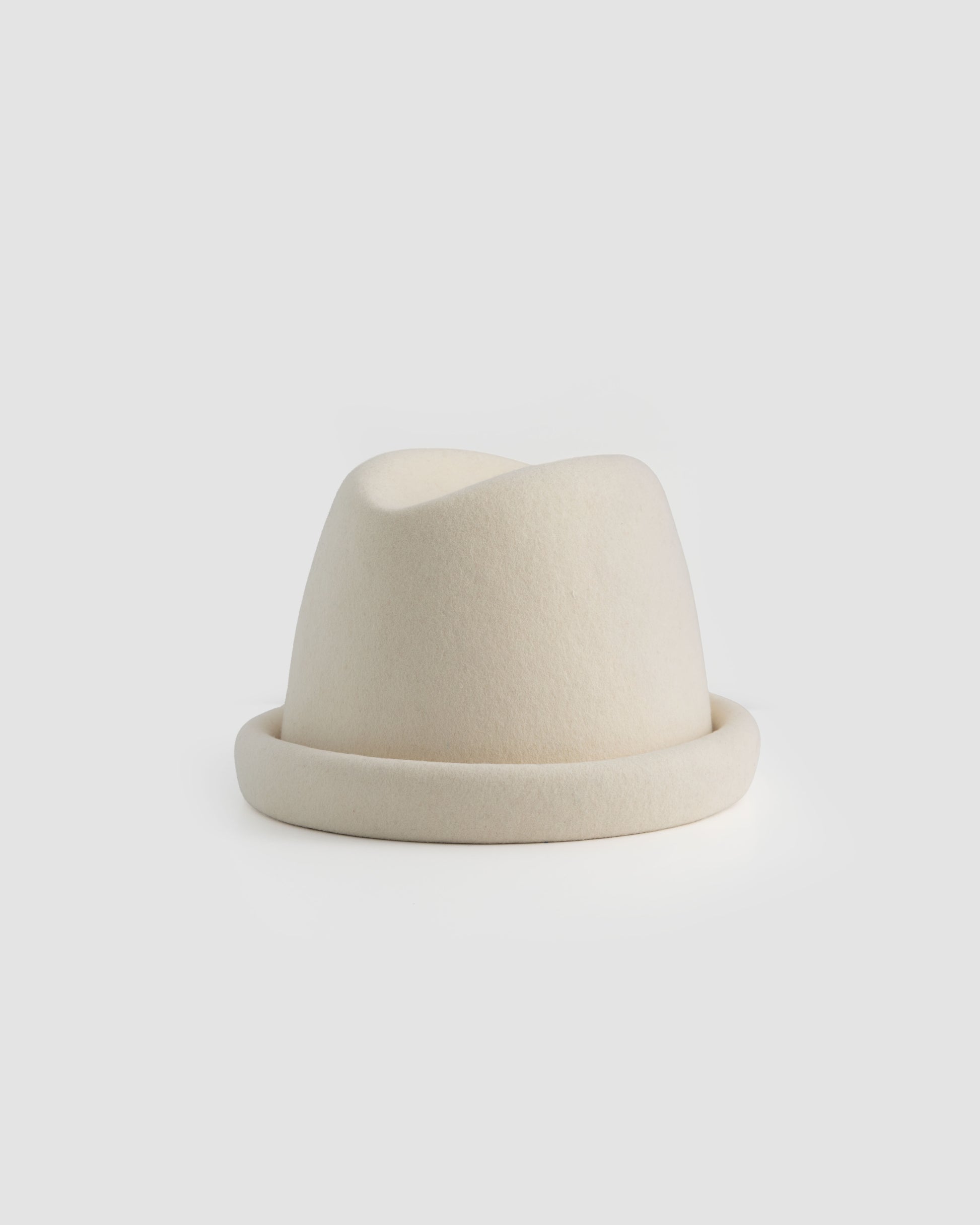 Ivory Russian pillbox hat by Born To Roam featuring a sleek, rounded design and elegant style.
