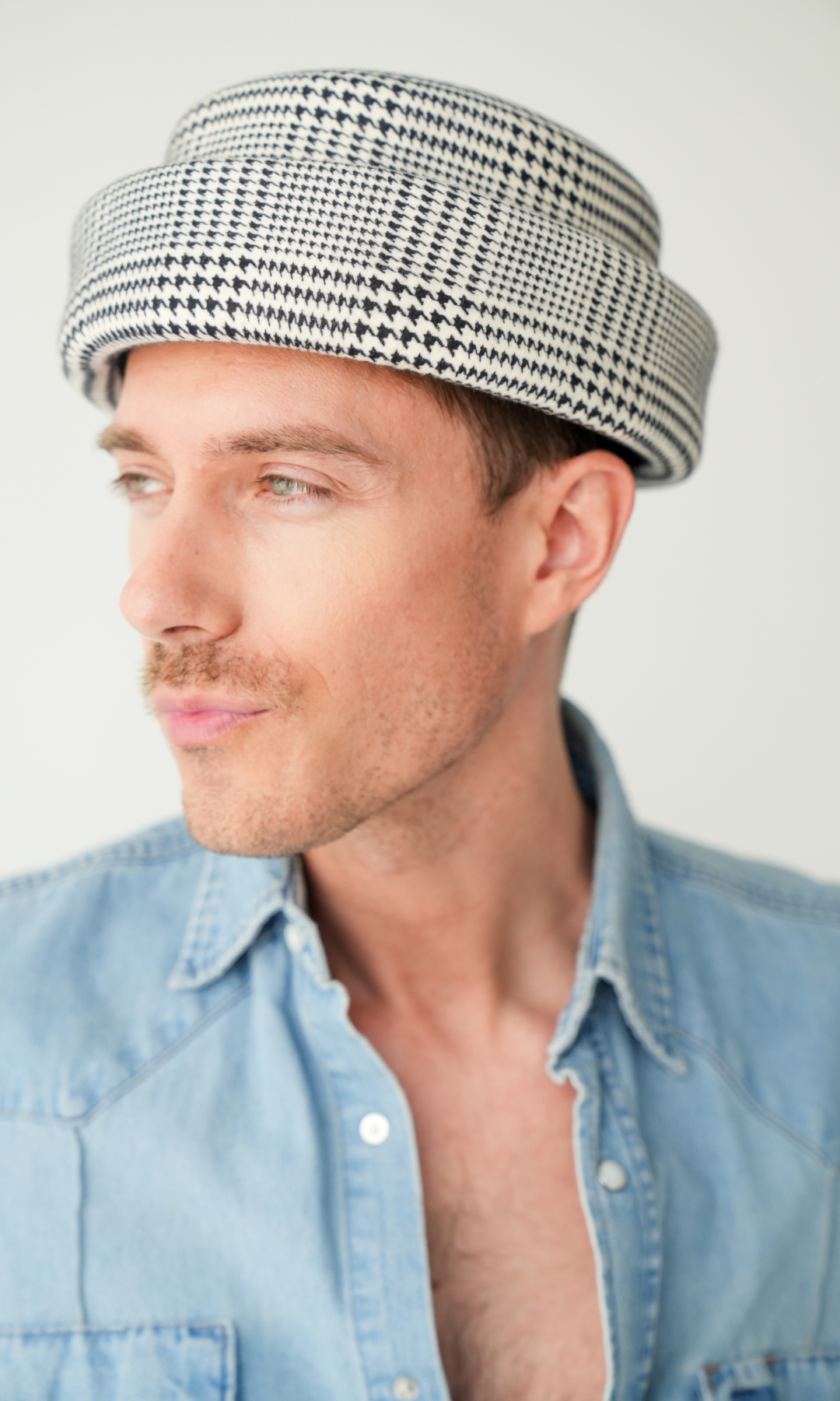 Born To Roam London Pillbox Hat in classic Glen plaid, featuring a sleek, structured design perfect for stylish accessories.