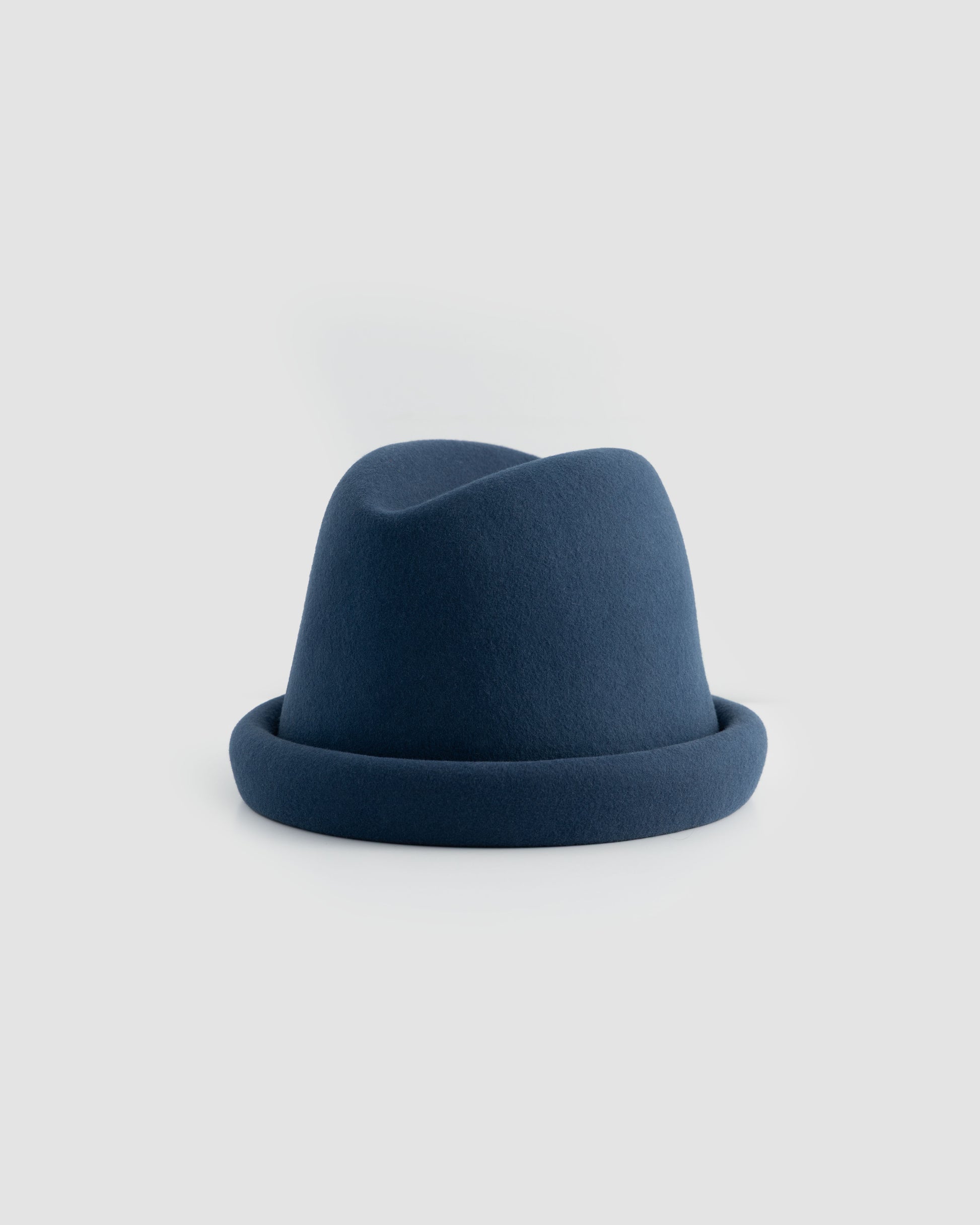 Navy Russian pillbox hat by Born To Roam featuring a sleek, structured design with a small brim and classic style.
