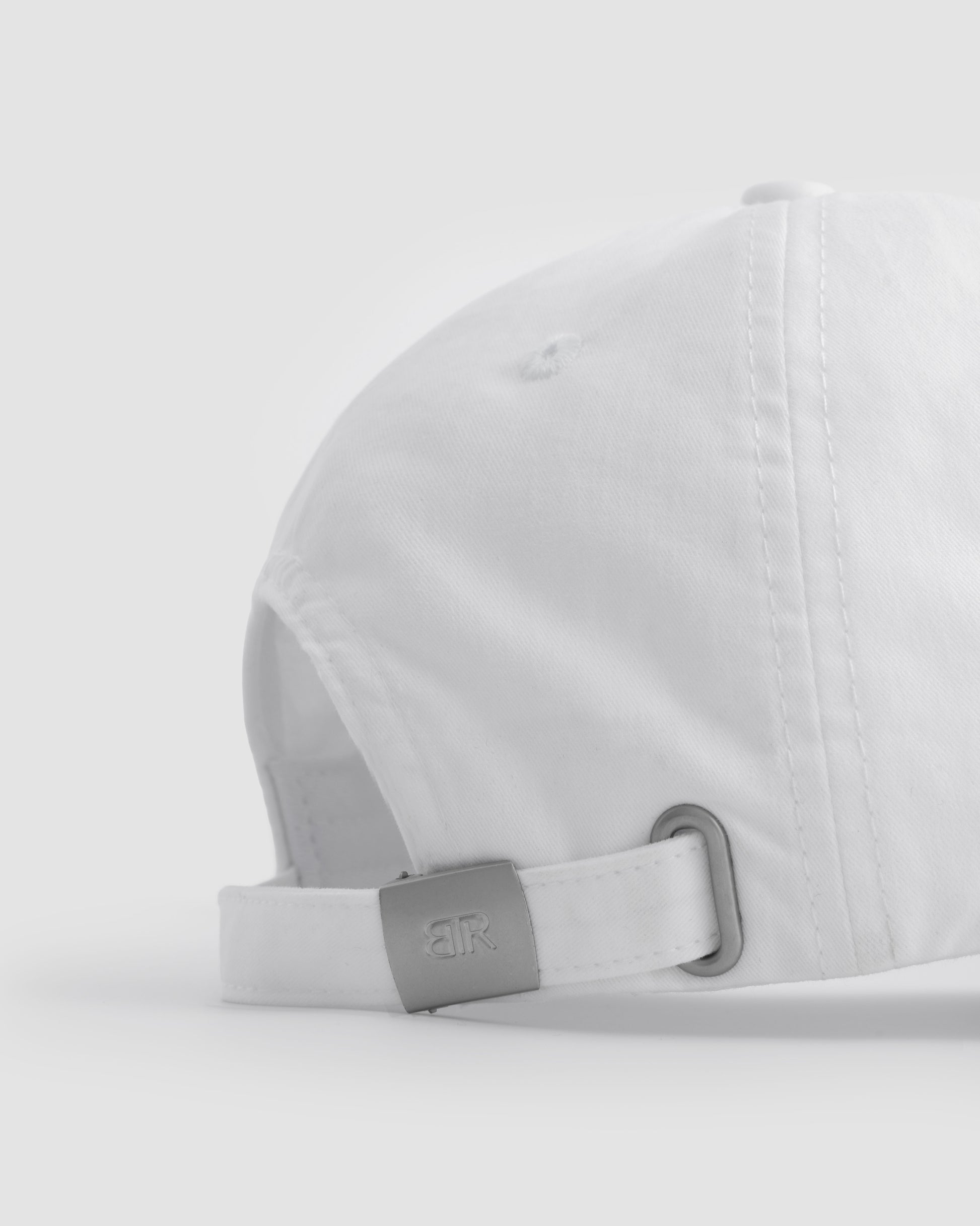 Born To Roam Queens baseball cap in classic white, featuring a structured design and adjustable strap.