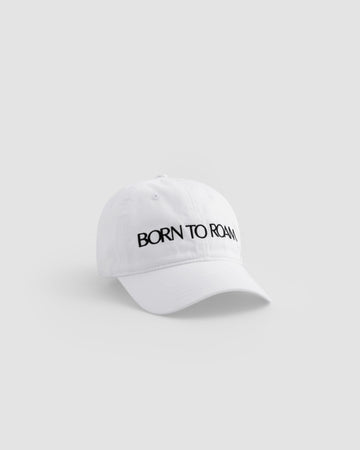 Born To Roam Queens Baseball Cap in classic white, featuring a structured brim and adjustable strap for a casual outdoor look.