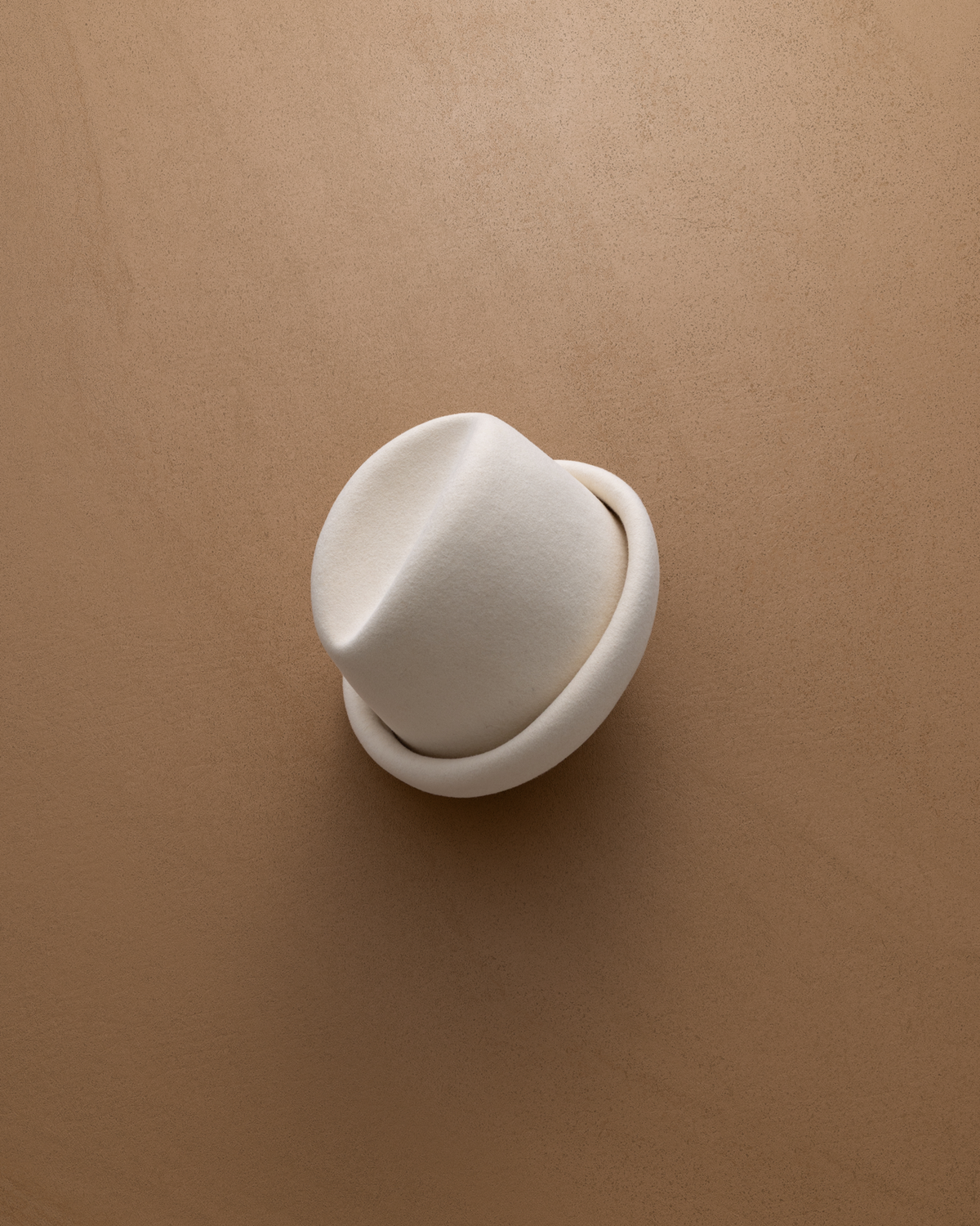 Born To Roam ivory Alpine pillbox hat with a sleek, structured design, perfect for stylish accessories or outdoor fashion.