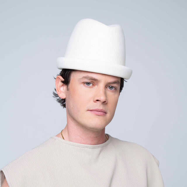 Ivory Russian pillbox hat by Born To Roam featuring a sleek, structured design with a small brim and elegant finish.