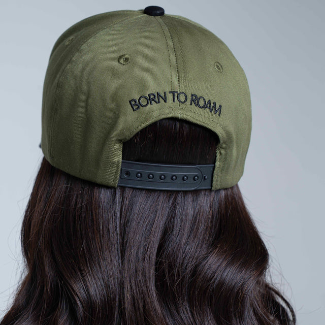 Olive green American Trucker Cap by Born To Roam featuring mesh back and curved brim, classic baseball cap style.
