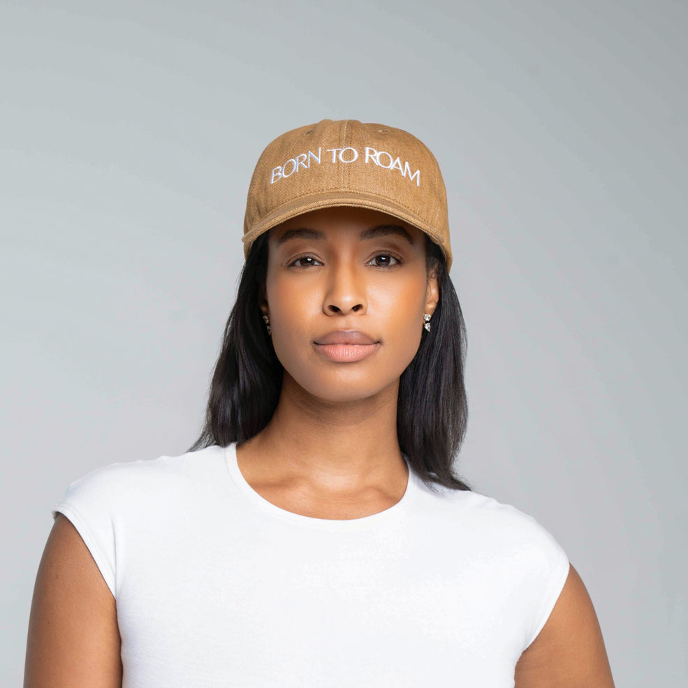 Born To Roam Queens baseball cap in khaki, featuring a classic curved brim and adjustable strap for a comfortable fit.