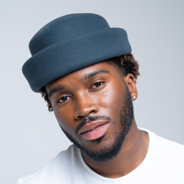 Navy London Pillbox hat by Born To Roam featuring a classic round design and elegant style.