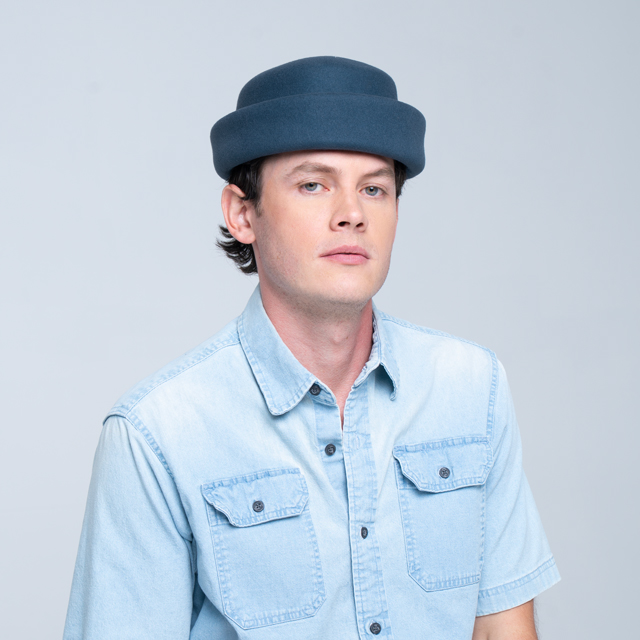 Navy London Pillbox hat by Born To Roam with a sleek, structured design and a decorative bow detail.