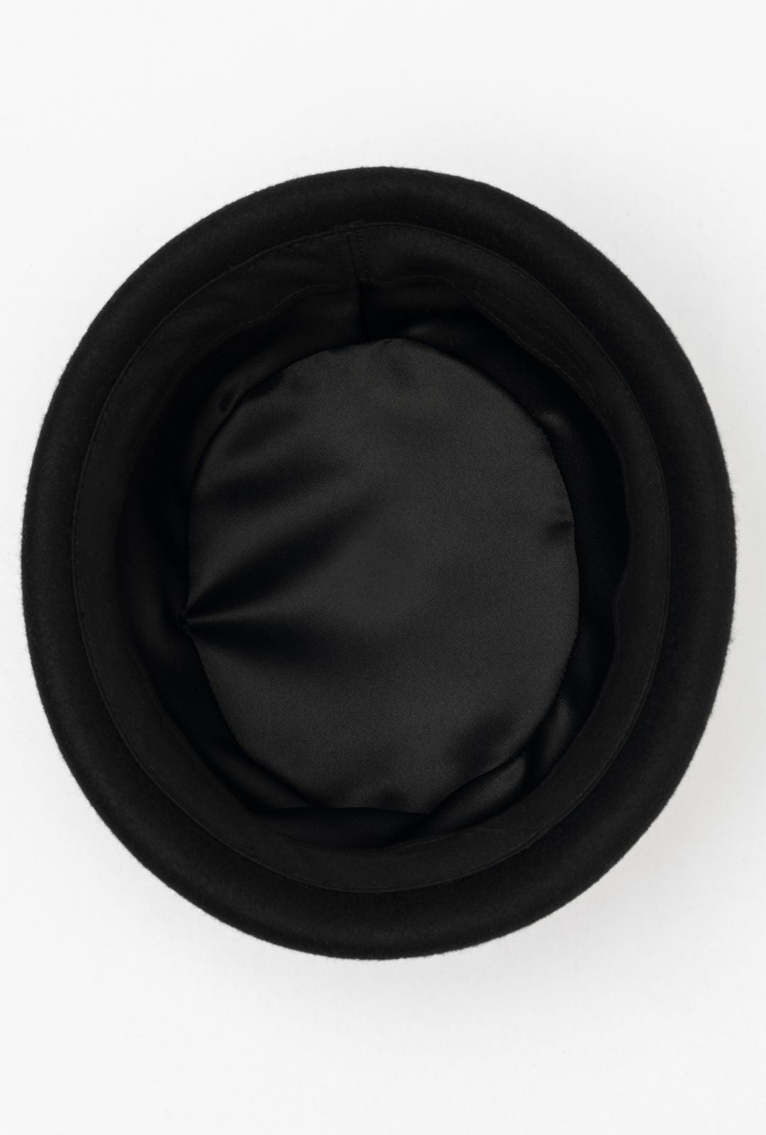 Black London Pillbox hat by Born To Roam with sleek design and structured shape, shown with black lining.