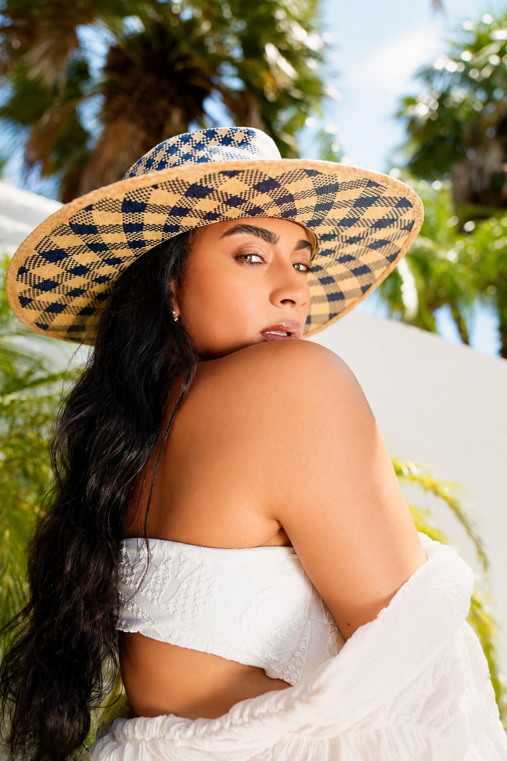 Born To Roam Rosewood Fedora Straw Hat, stylish wide-brim hat with a classic fedora shape and straw material, displayed on a shoulder.