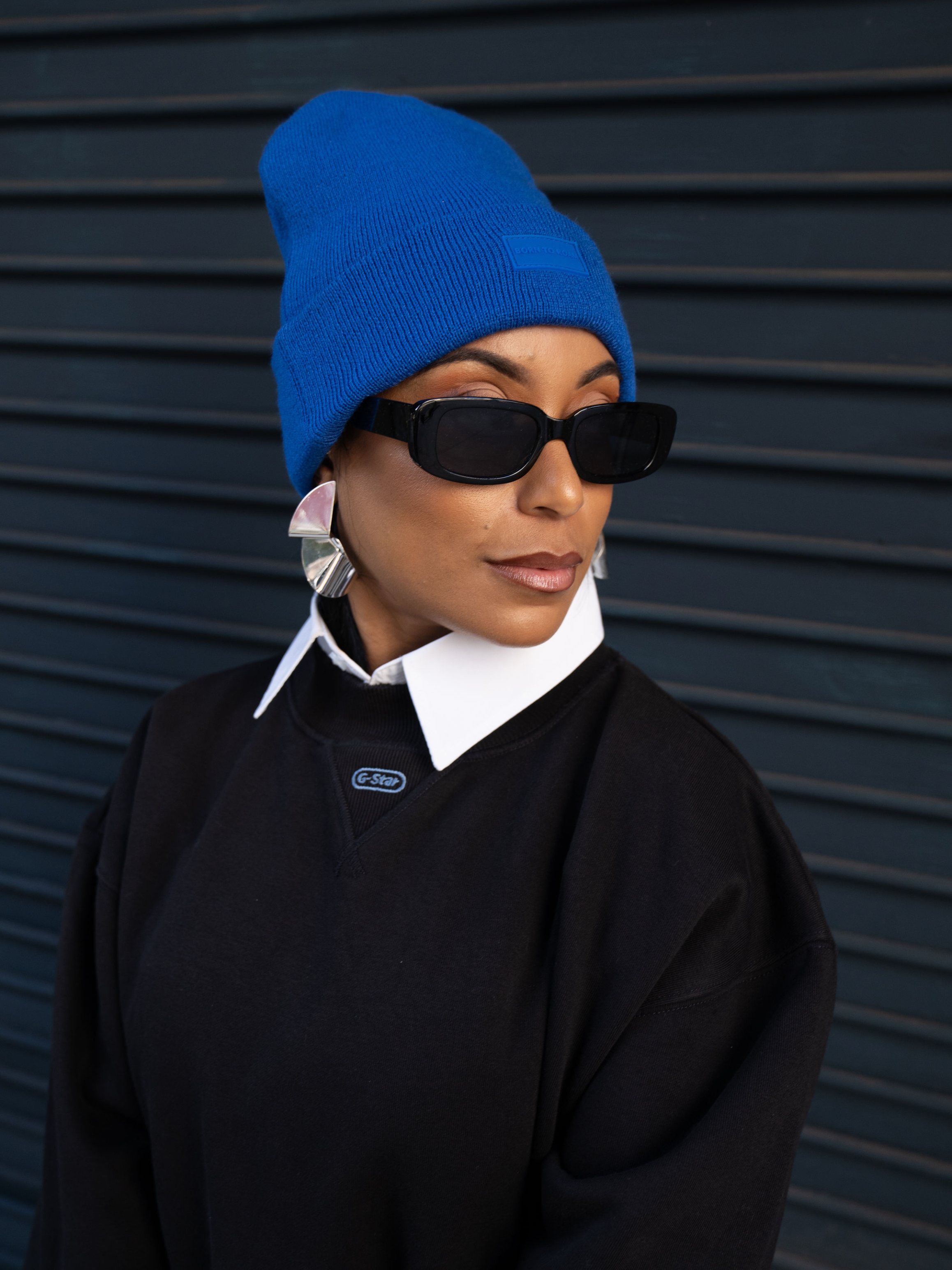Cobalt blue Vail Knit Beanie by Born To Roam, soft ribbed knit hat with a snug fit and folded brim, ideal for cold weather.