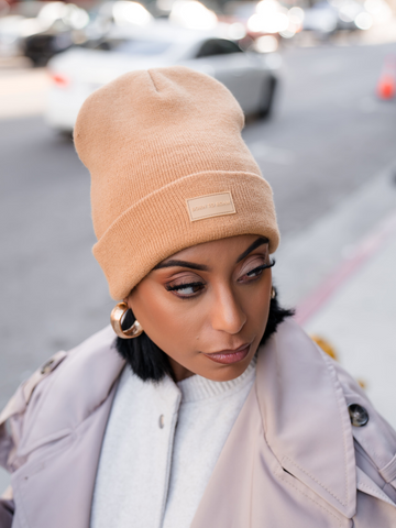 Born To Roam Vail Knit Beanie in tan, cozy knit hat with a folded brim, perfect for cold weather and casual style.