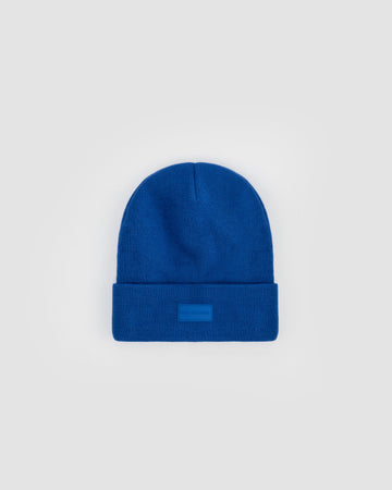 Born To Roam Vail Knit Beanie in vibrant cobalt blue, soft knit fabric, snug fit, perfect for cold weather.