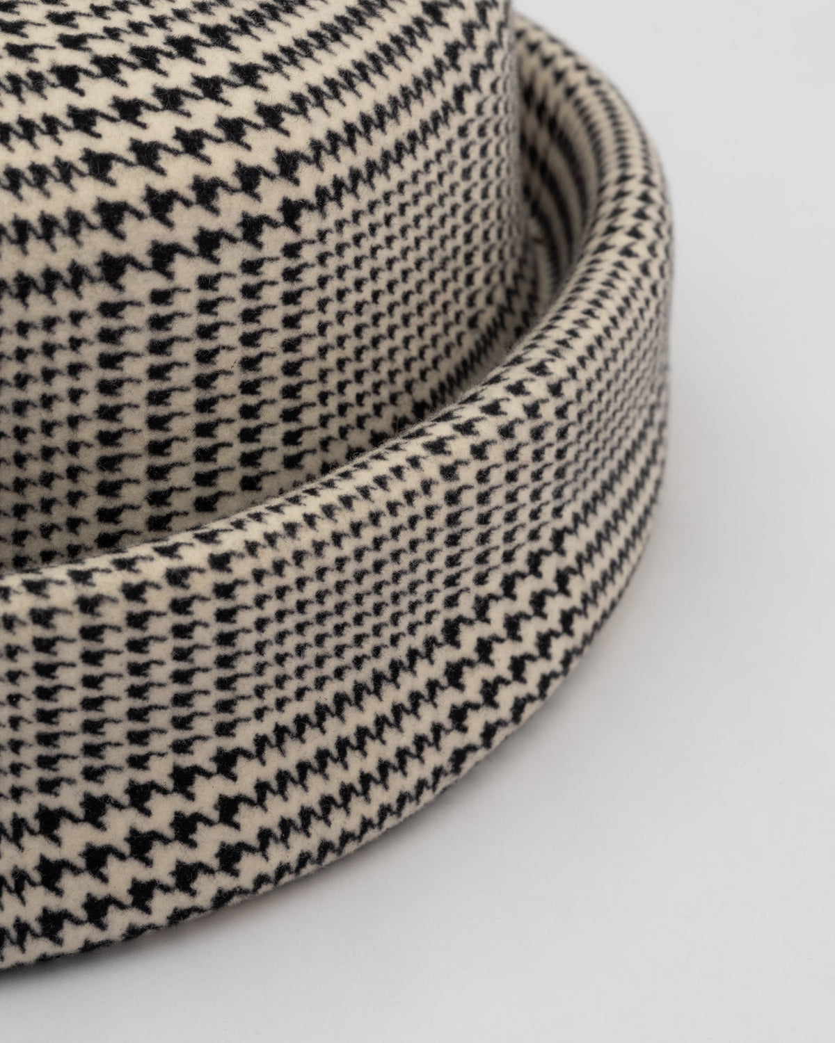 Born To Roam London Pillbox Hat in classic Glen Plaid with a sleek, structured design for a timeless fashion statement.