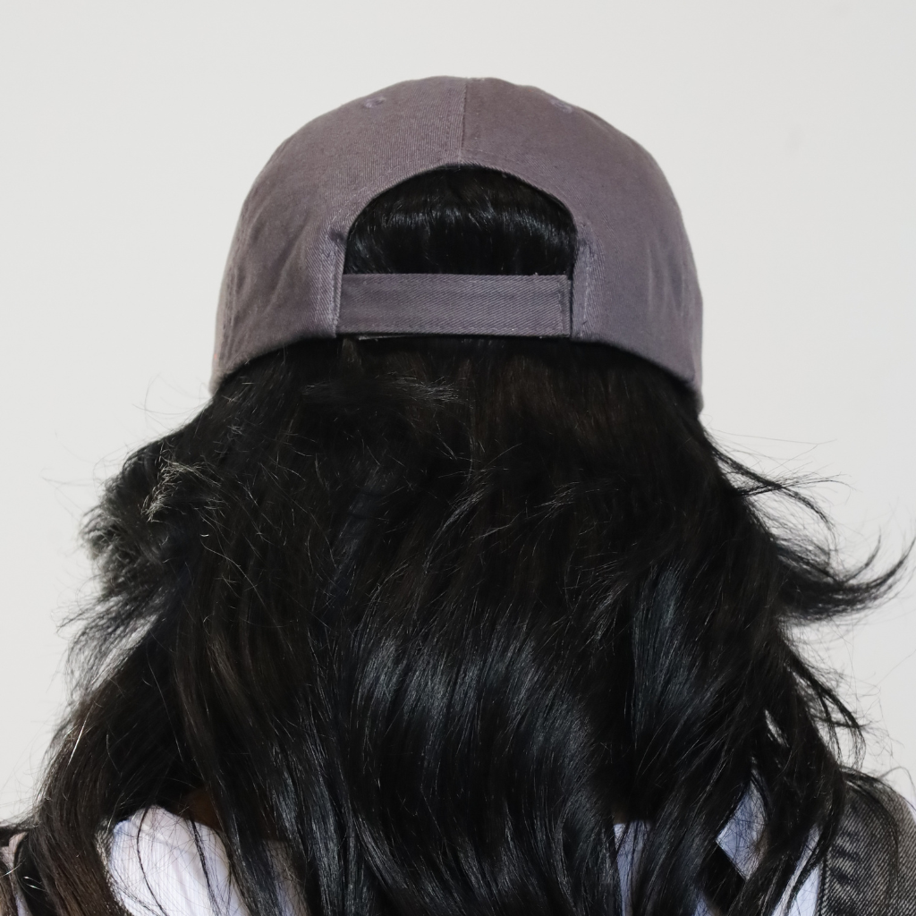 Model posing with smoke grey signature distressed baseball cap - back view