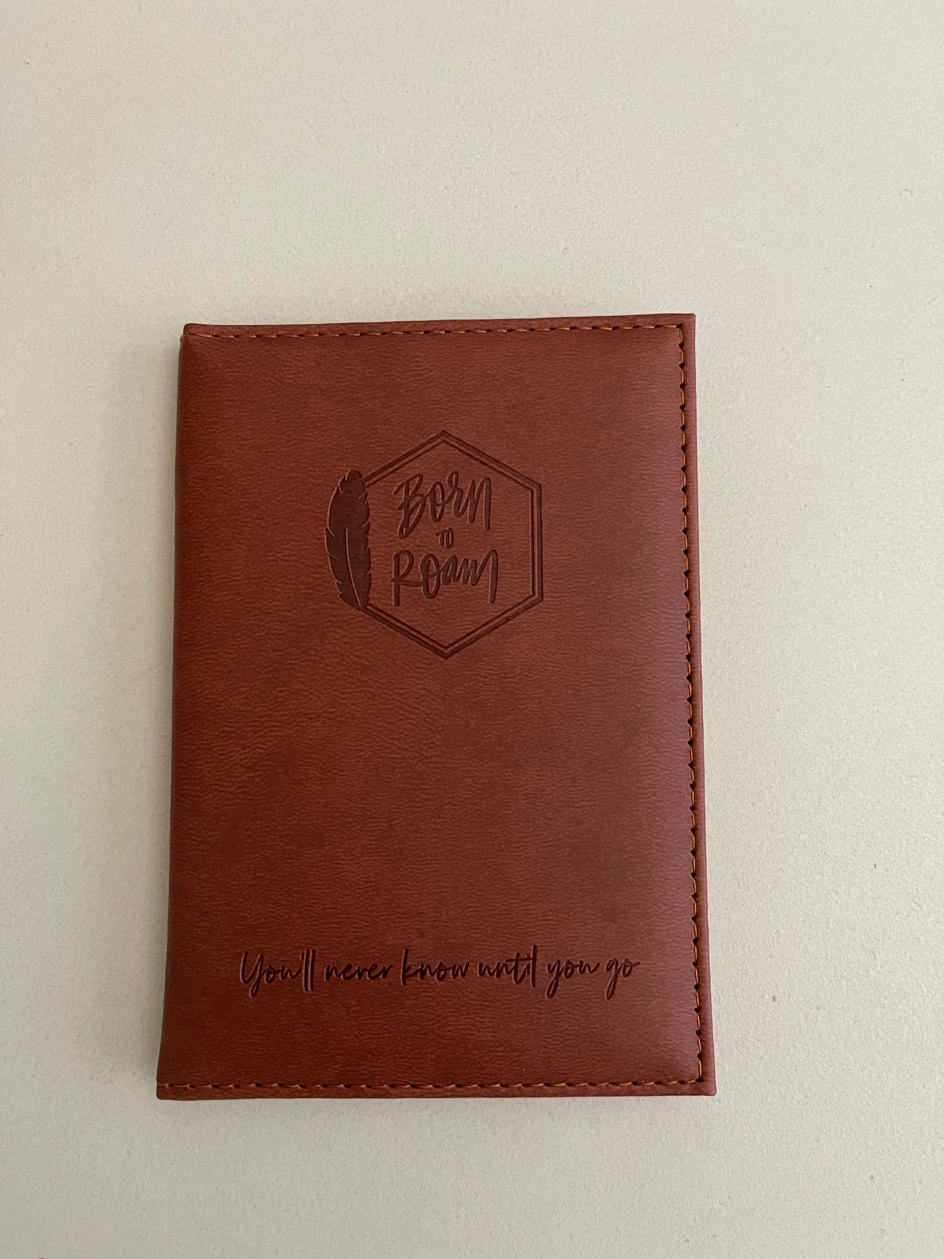 Born To Roam passport cover featuring a rugged design with logo branding and durable material for travel accessories.